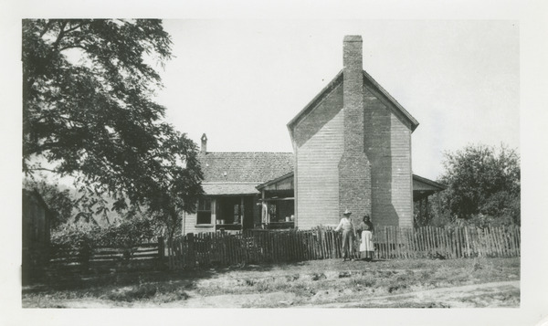 Noah and Sarah Burchfield in front of their house Thumbnail