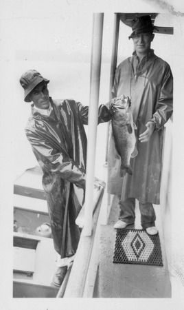 Estes Kefauver with unidentified man in foul weather gear with fish Miniaturansicht